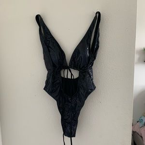 This one piece black swimsuit will be sure to make jaws drop.Never been worn!